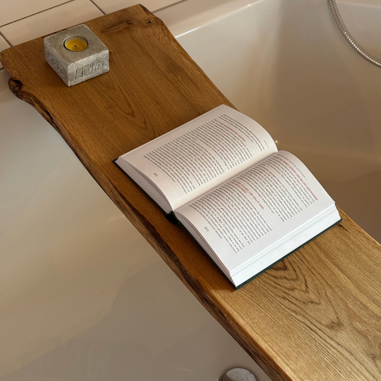 Badewannenbrett mit Kerze Buch auf leerer Badewanne